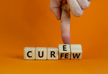 Curfew and cure symbol. Businessman turns cubes and changes the word 'curfew' to 'cure'. Beautiful orange background. Business, curfew and cure concept. Copy space.