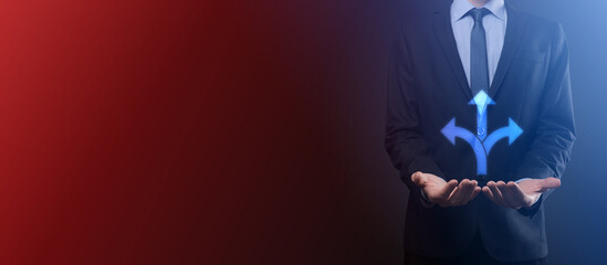 Businessman in a suit holds a sign showing three directions. in doubt, having to choose between three different choices indicated by arrows pointing in opposite direction concept. three ways to choose
