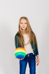 Beautiful girl holding coloured bright ball isolated on white