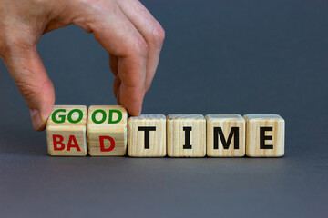 Good or bad time symbol. Businessman turns wooden cubes and changes words 'bad time' to 'good...