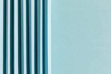 Abstract light blue colored paper texture. Folded paper with harsh sun shadows, geometric shapes...