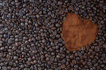 Background of roasted coffee beans and ground coffee forming a heart
