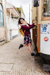 young caucasian backpacker woman sightseeing Porto views standing on a train. Travel concept