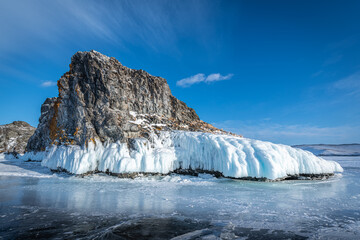 Fototapeta na wymiar Rocky island among the Baikal ice
