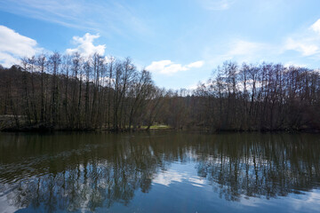 beautiful river with blue water and mirrored clouds