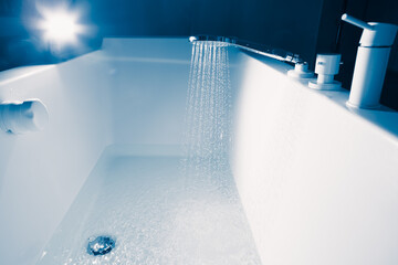 douche filling a bathtub with water stream