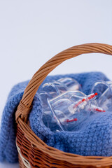 Jars for hijama in a basket in the snow. Wicker basket. Bloodletting according to the Sunnah. Vacuum therapy. medical and health concept. Winter and snow.