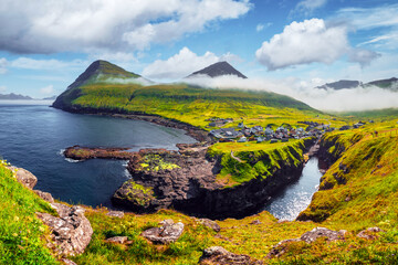 Picturesque view on village of Gjogv with typically colourful houses on the Eysturoy island, Faroe...