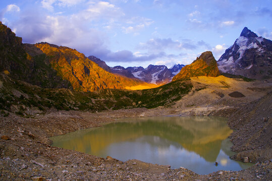 Sunset on Lake Bashkara against the background of the Caucasian Wall in the Elbrus region