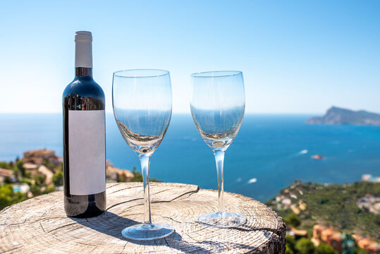 Coastal landscape with Bottle of wine with two glasses and the sea in the background