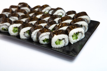 Fresh delicious japanese sushi with avocado on white background.