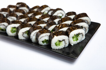 Fresh delicious japanese sushi with avocado on white background.