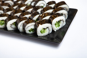 Fresh delicious japanese sushi with avocado on white background.