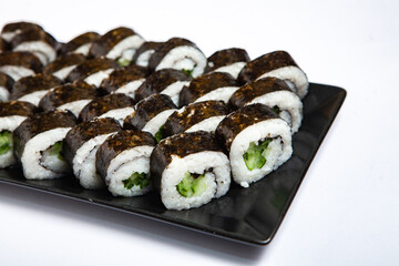Fresh delicious japanese sushi with avocado on white background.