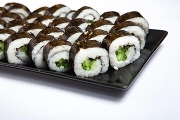 Fresh delicious japanese sushi with avocado on white background.