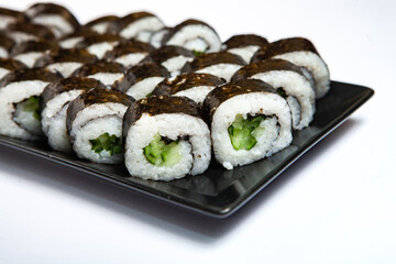 Fresh delicious japanese sushi with avocado on white background.