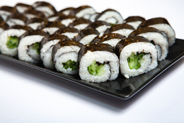 Fresh delicious japanese sushi with avocado on white background.