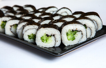 Fresh delicious japanese sushi with avocado on white background.