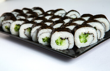 Fresh delicious japanese sushi with avocado on white background.