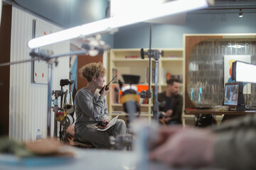 Director at work on the set. The director works with a group or with a playback while filming a...