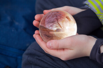 Shinig glass ball in child hands