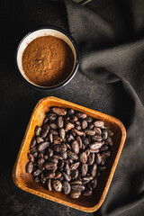 Cocoa powder and cocoa beans in bowl.
