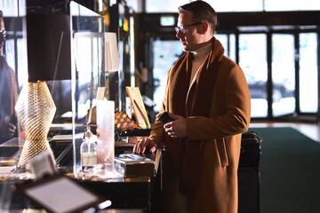 Man In Spectacles having nice talk with hotel receptionist