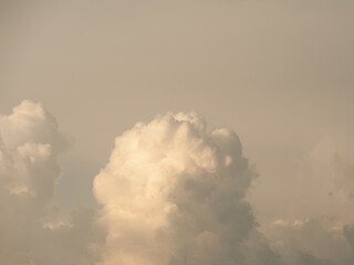 A piece of sky with dramatic, voluminous, storm clouds.