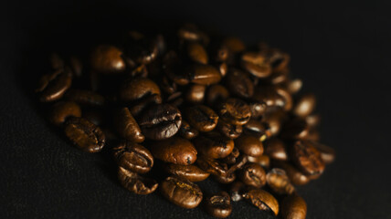 Fototapeta premium Brown Roasted Coffee Beans Closeup On Dark Background