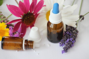 Bottles, globulis with lavender and sun hat/background for naturopathy and homeopathy