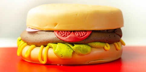 Burger Cake, Madeira and chocolate sponge layered cake, filled with frosting covered with soft icing and edible sugar decorations