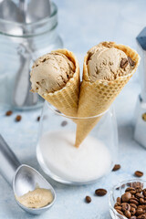 Coffee ice cream in a waffle cone in a glass. Delicious summer dessert. Selective focus. 