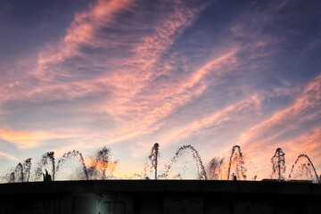 Fountain with water in motion at sunset