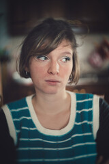 portrait of a pensive smart woman with striped sweater
