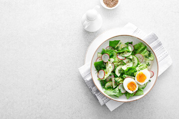 Salad with radish, cucumber, romaine lettuce, greens and boiled egg. Breakfast. Healthy and detox food concept.