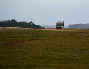 Fototapeta premium british army land rover defender 4x4 traversing a ditch