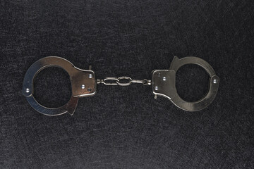 Closeup shot of handcuffs isolated on black background