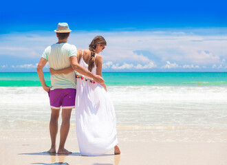 young couple on their honeymoon having fun by tropical beach