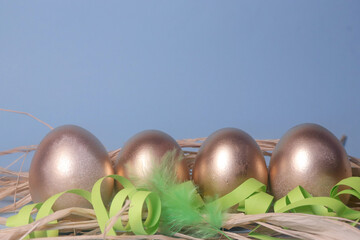 easter eggs in a nest. easter eggs. painted golden eggs. eggs for easter. the holiday table.