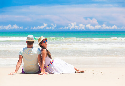 young couple on their honeymoon having fun by tropical beach