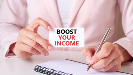 a card in the hands of a woman with the inscription boost your income