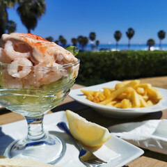 Small unshelled shrimps cocktail in the bowl with pink sauce