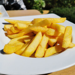 Fast food french fries on summer terrace or cafe