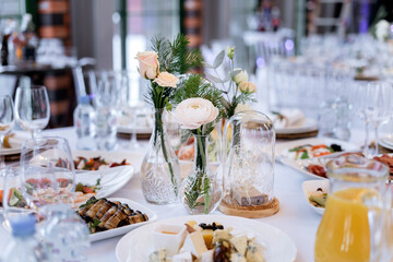 Table set for an event party or wedding reception. There is a lot of varied food on the table, luxury catering.