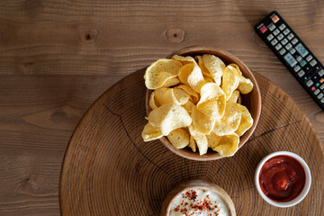 eating chips and watching tv at home