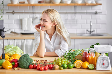 blonde pleasant woman of european appearance like healthy eating, stand by table with fresh food