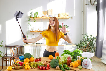 charming woman greeting followers and subscribers at smartphone camera