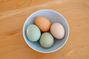 Bowl of colorful brown and grey free-range pasture-raised organic eggs from heritage hens