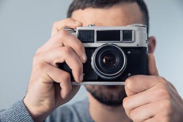 man holding vintage camera