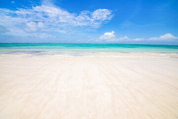 seascape, ocean shore, clouds and sun in the sky